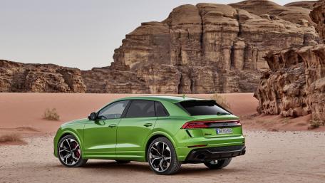 Vibrant Green SUV in Desert Landscape wallpaper