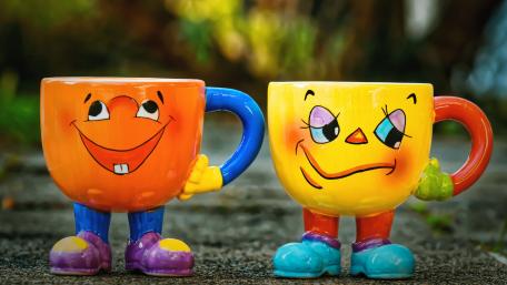 Cheerful Cartoon Mugs Bringing Joyful Vibes wallpaper