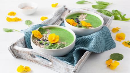 Vibrant Green Smoothie Bowls Decorated with Edible Flowers wallpaper