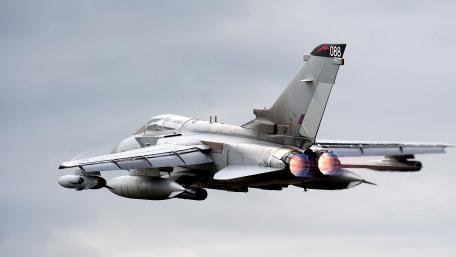 Sleek Military Jet in Action Under Dramatic Skies wallpaper