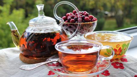Warm Tea and Fresh Berries Delightful Relaxation Moment wallpaper