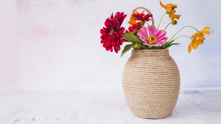 Vibrant Floral Arrangement in a Rustic Vase wallpaper