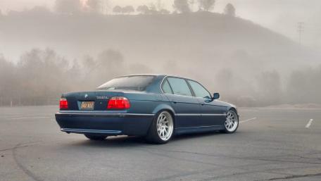 Sleek Car in Mysterious Foggy Landscape wallpaper