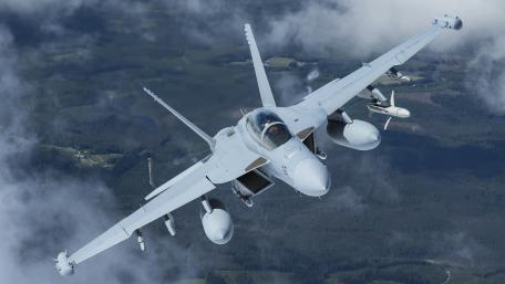 Sleek Fighter Jet in Flight Over Clouds wallpaper