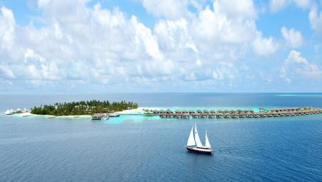 Serene Sailboat Journey Across Tranquil Waters wallpaper