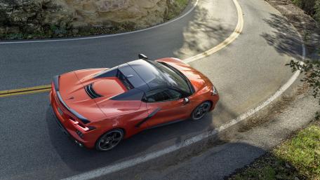 Sleek Red Sports Car on Mountain Roadway wallpaper