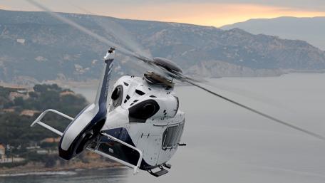 High-Flying Adventure of a Helicopter Above the Coastline wallpaper