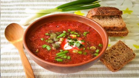 Vibrant Red Soup with Fresh Ingredients and Bread wallpaper