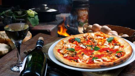 Delicious Gourmet Pizza with Wine and Ingredients wallpaper