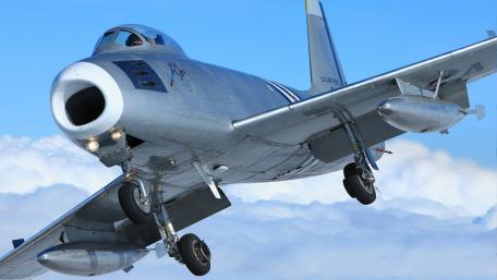 Majestic Military Aircraft Soaring Above the Clouds wallpaper