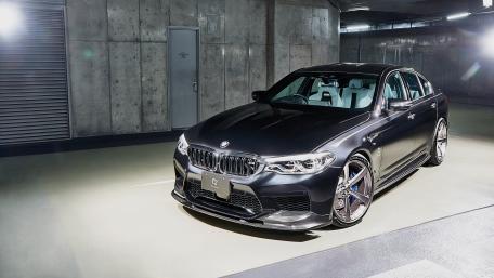 Sleek Black BMW in Urban Garage Setting wallpaper