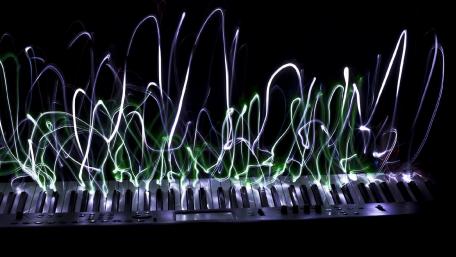 Rhythmic Light Waves on a Keyboard wallpaper