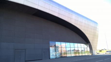 Modern City Architecture with Sleek Design and Reflection in Glass Panels wallpaper