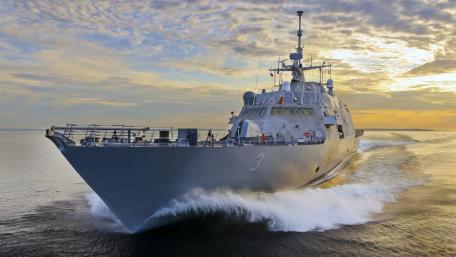 Majestic Warship Navigating the Sea at Dusk wallpaper