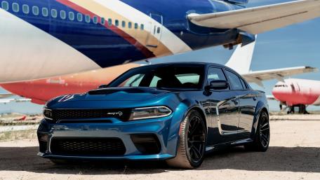 Sleek Charger Against a Vintage Jetliner wallpaper