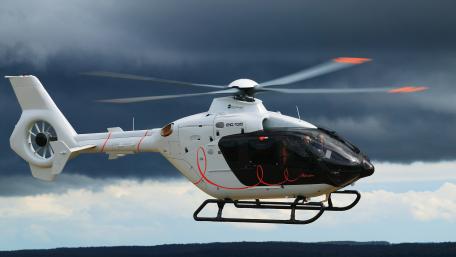 Sleek Helicopter Against Dramatic Sky wallpaper
