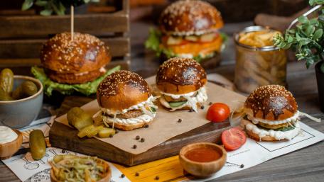 Delicious Gourmet Burgers and Sides Displayed wallpaper