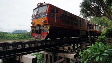 Vibrant Train Journey Through Lush Scenery wallpaper
