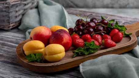 Vibrant Fruit Display on Wooden Platter wallpaper