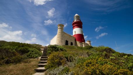 Serene Lighthouse Amidst Nature's Splendor wallpaper