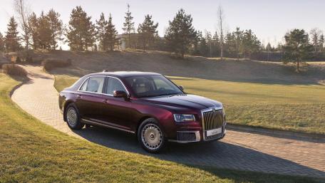Elegant Luxury Sedan on a Serene Landscape wallpaper