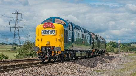 Vibrant Diesel Locomotive on Scenic Tracks wallpaper