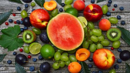 Vibrant Fruit Spread on Rustic Wooden Background wallpaper
