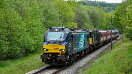 Modern Train Gliding Through Lush Greenery wallpaper