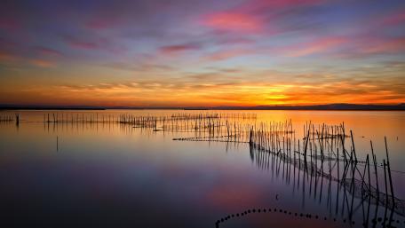 Serene Sunset Reflections Over Tranquil Waters wallpaper