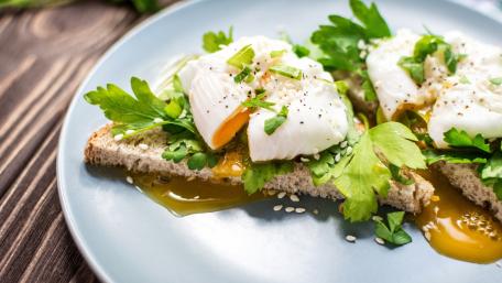 Delicious Breakfast Sandwich with Poached Eggs and Greens wallpaper