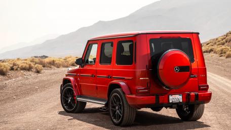 Bold Red SUV on a Desert Roadway wallpaper