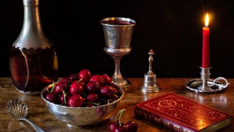 Elegant Still Life with Cherries and Candlelight wallpaper