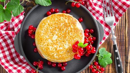 Delightful Pancakes Surrounded by Fresh Berries wallpaper