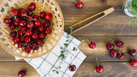Fresh Cherries in a Rustic Basket wallpaper