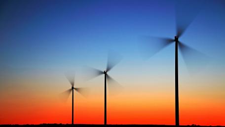 Wind Turbines Against a Vibrant Sunset Sky wallpaper