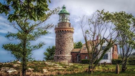Serene Lighthouse Amidst Nature's Splendor wallpaper