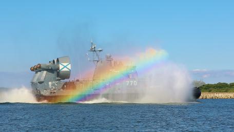 Majestic Naval Power Under a Rainbow wallpaper