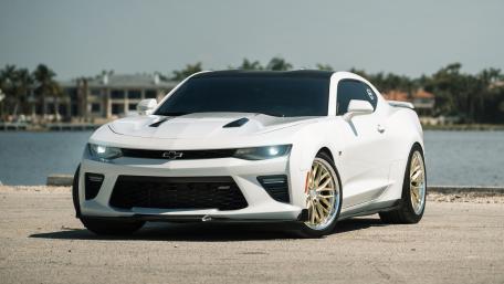 Sleek White Sports Car Under a Bright Sky wallpaper