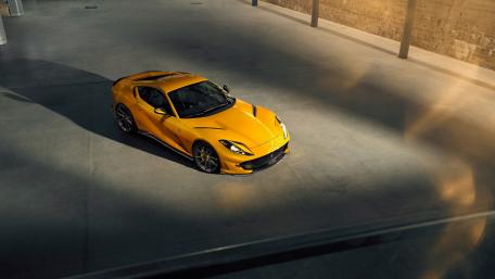 Sleek Yellow Sports Car in Modern Garage wallpaper