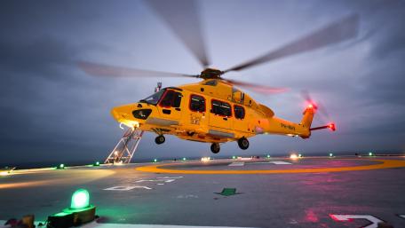 Yellow Helicopter in Action at Night Sky wallpaper