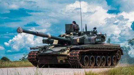 Powerful Tank on Open Terrain Under Blue Skies wallpaper