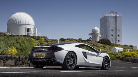 Sleek McLaren 570GT Against Scenic Observatory Background wallpaper