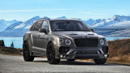 Sleek Luxury SUV Against Majestic Mountainscape wallpaper
