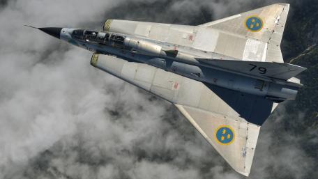 Elegant Swedish Jet in Flight Above Clouds wallpaper