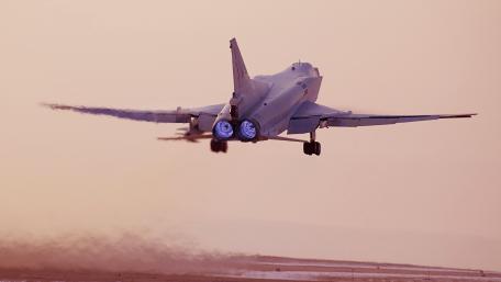 Majestic Bomber Taking Flight in Sunset Glow wallpaper