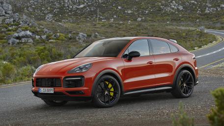 Sleek Porsche Cayenne Coupe on a Scenic Road wallpaper