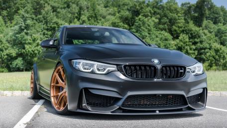 Sleek BMW with Stylish Wheels in Nature Setting wallpaper