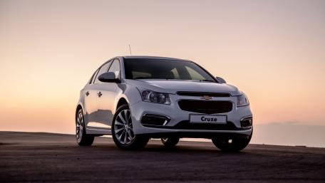 Sleek Chevrolet Cruze at Sunset Driveway Perspective wallpaper