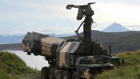 Advanced Military Vehicle Under Majestic Mountain View wallpaper