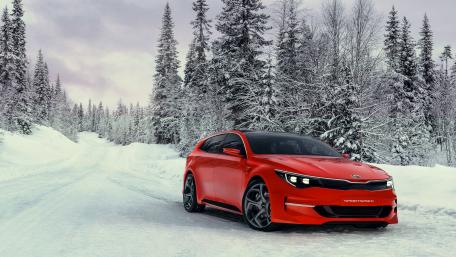 Vibrant Red Car in Winter Wonderland Scene wallpaper